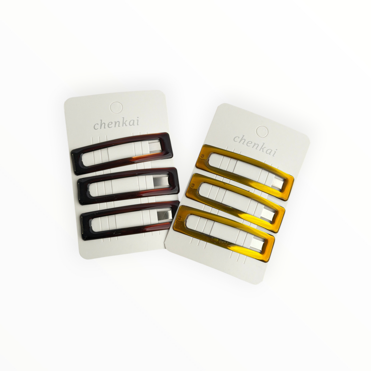 CE Collection rectangular hair clips in dark tortoiseshell and amber resin on display cards