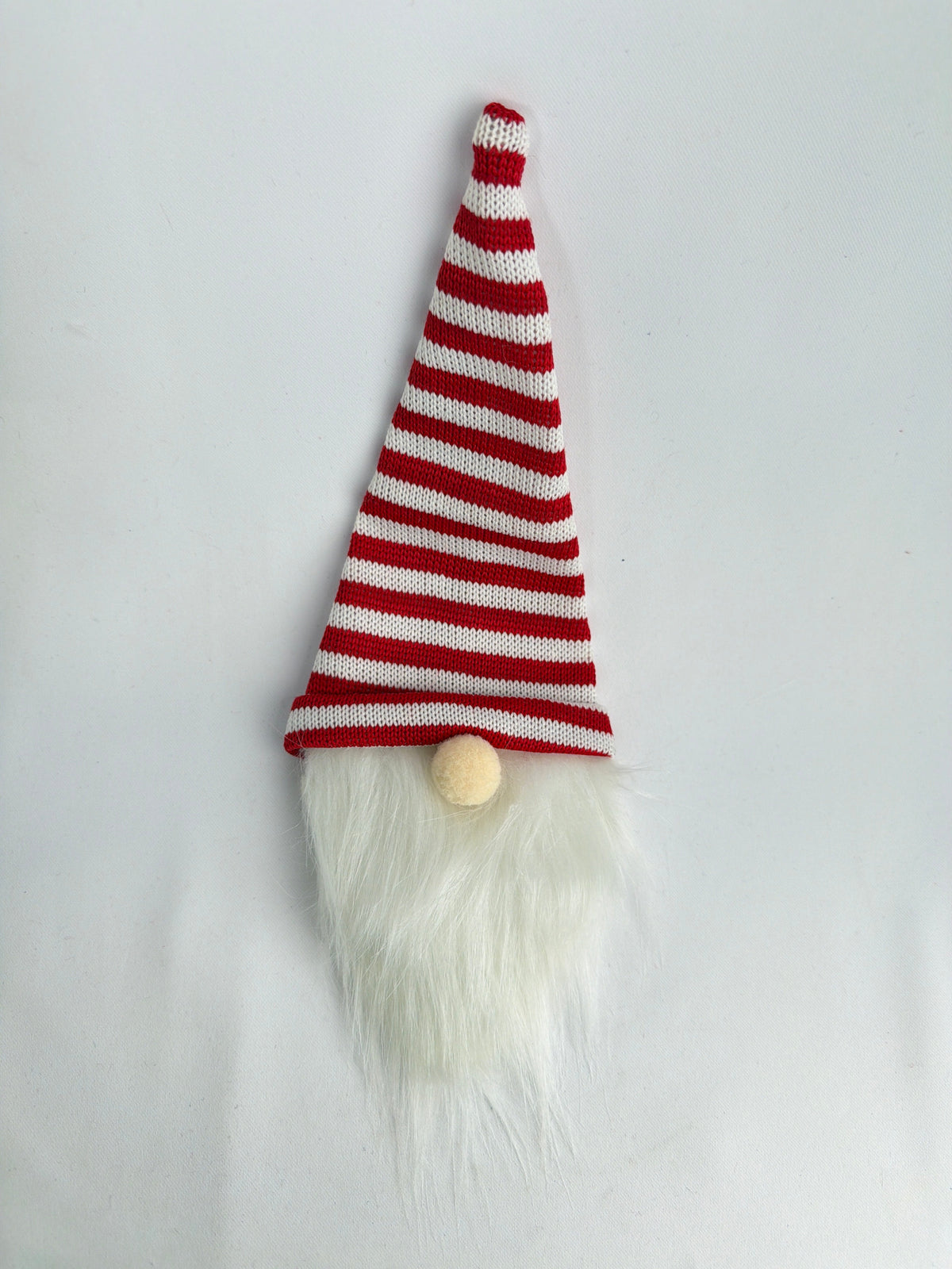 CE Collection wine bottle cover featuring a festive red and white striped gnome hat with a long white faux fur beard