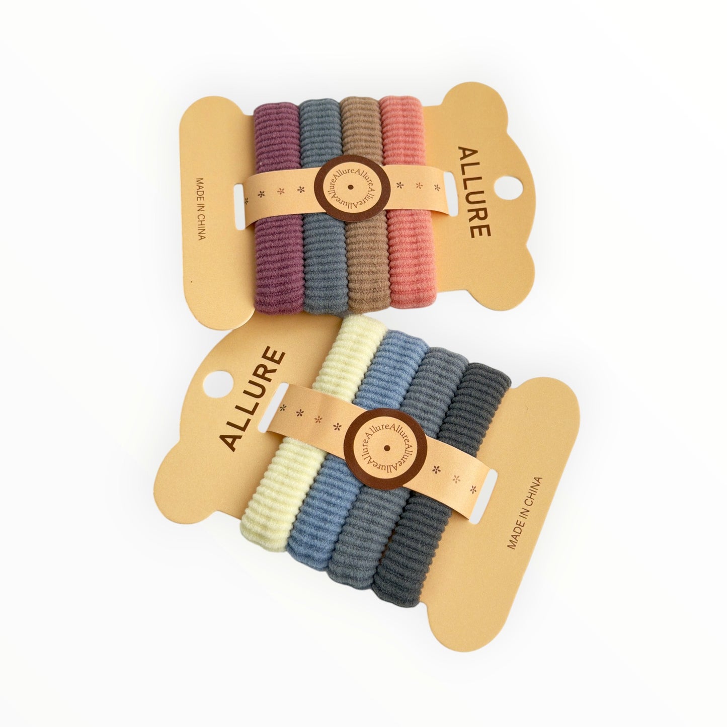 CE Collection hair elastics in two colorways: plum, grey, brown, pink and cream, light blue, grey, dark grey. 4 elastics per card, 12 cards per pack.