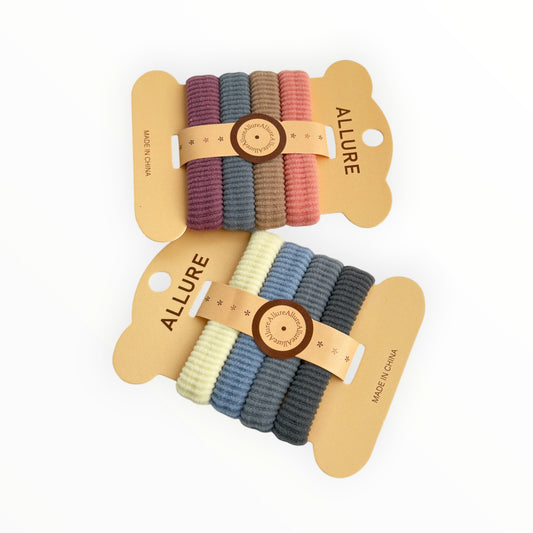 CE Collection hair elastics in two colorways: plum, grey, brown, pink and cream, light blue, grey, dark grey. 4 elastics per card, 12 cards per pack.