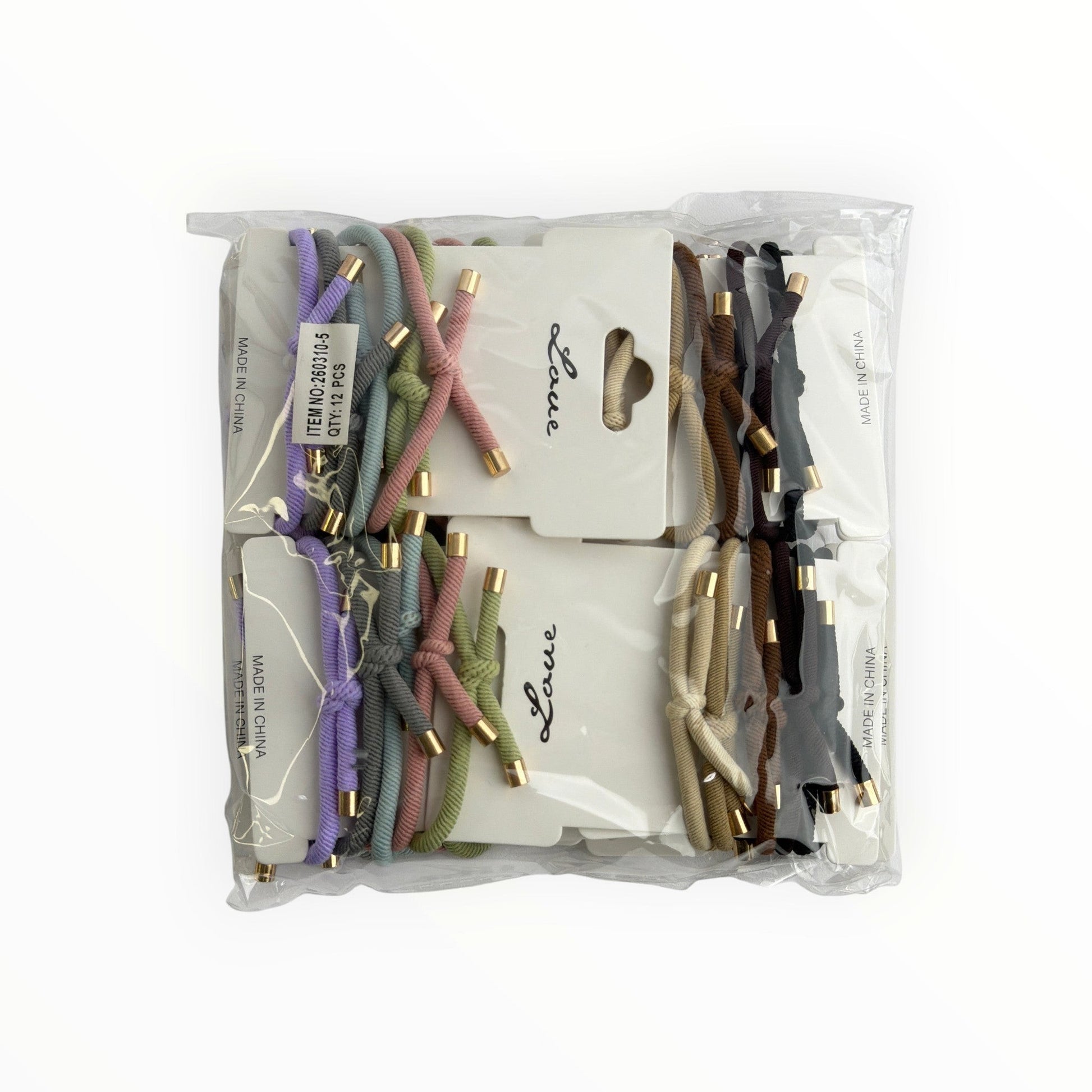 CE Collection hair elastics in pastel and neutral tones with gold accents, 12 cards per pack.